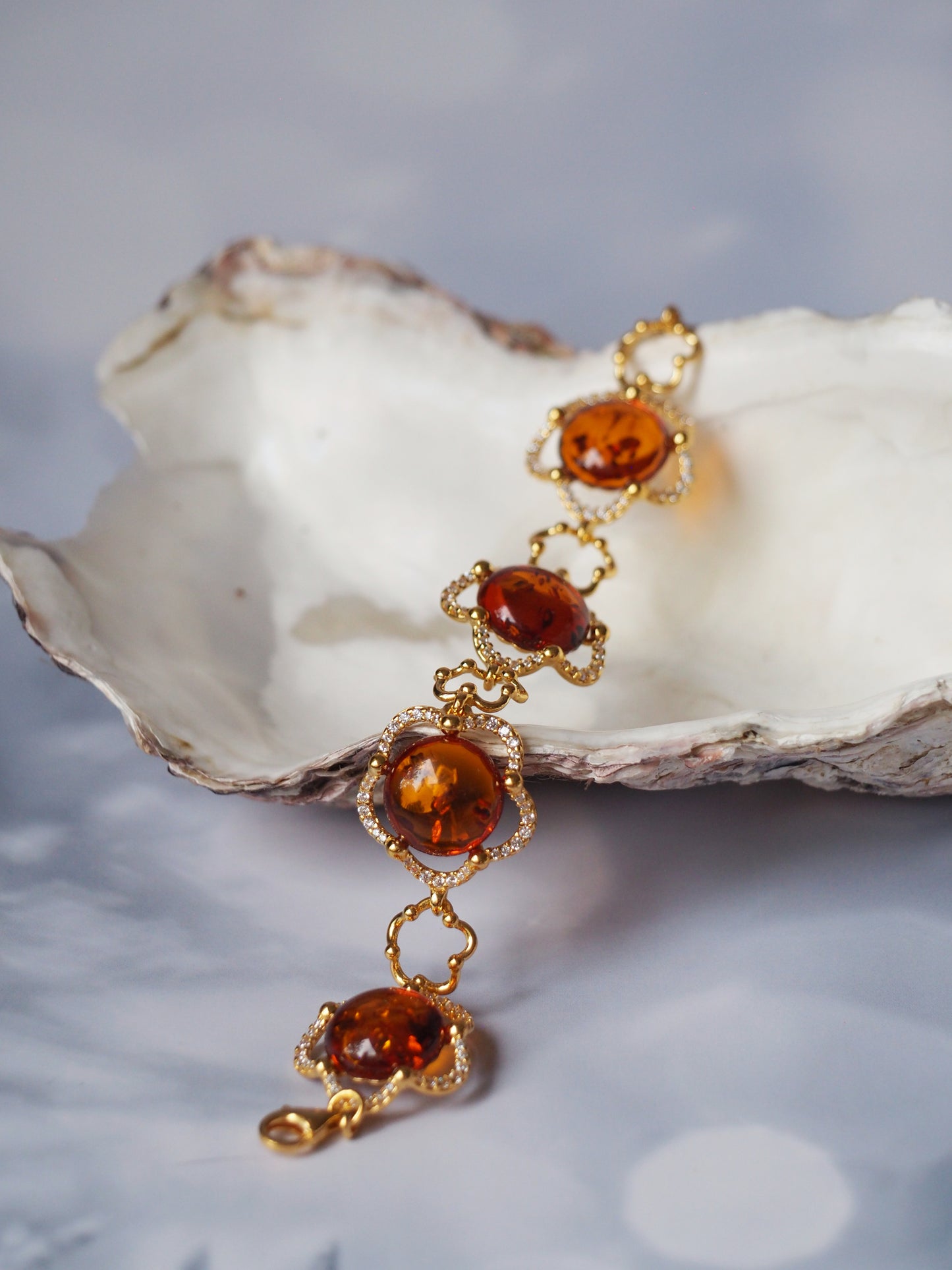 Delicate Flower Shaped Cognac Amber Bracelet with Cubic Zirconia in Gold Plated Silver