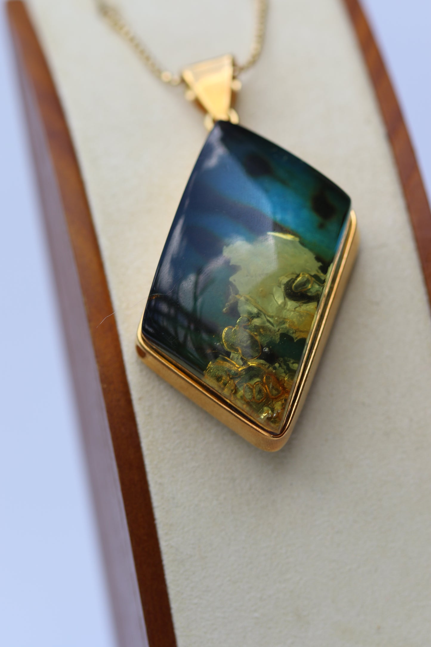 Unique Rhombus Shaped Blue Amber Pendant with Natural Inclusions in Gold Plated Silver