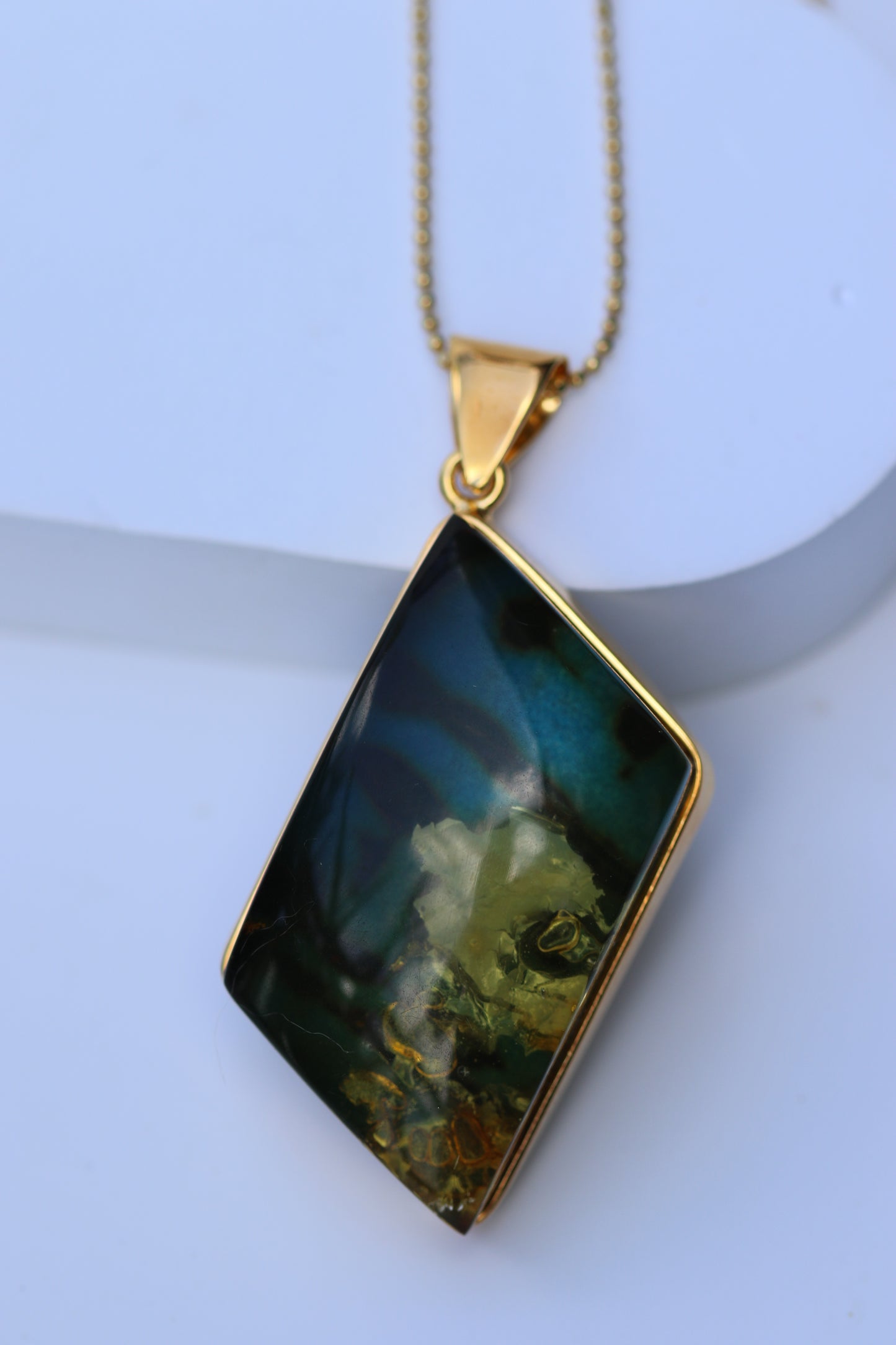 Unique Rhombus Shaped Blue Amber Pendant with Natural Inclusions in Gold Plated Silver