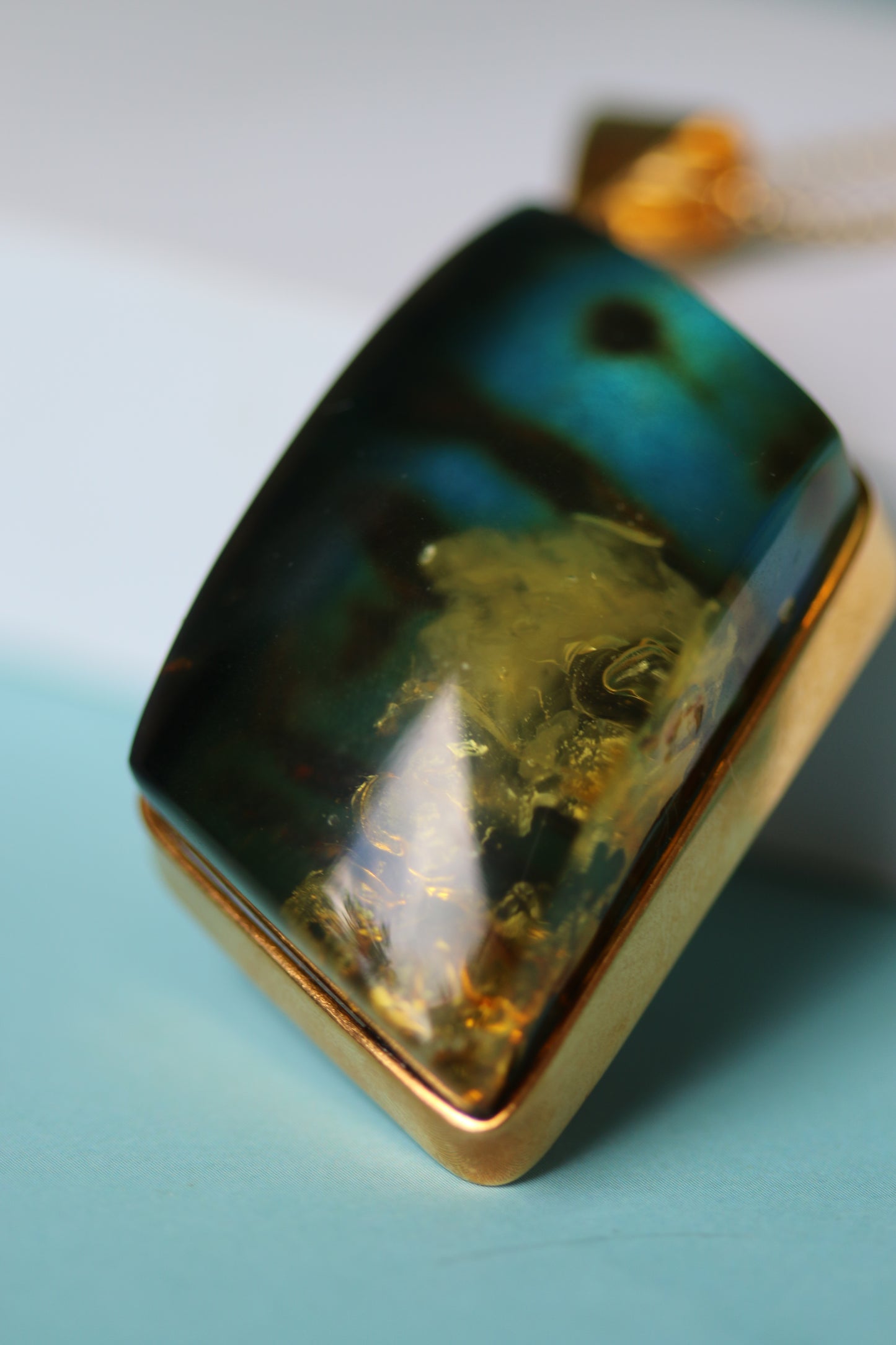Unique Rhombus Shaped Blue Amber Pendant with Natural Inclusions in Gold Plated Silver