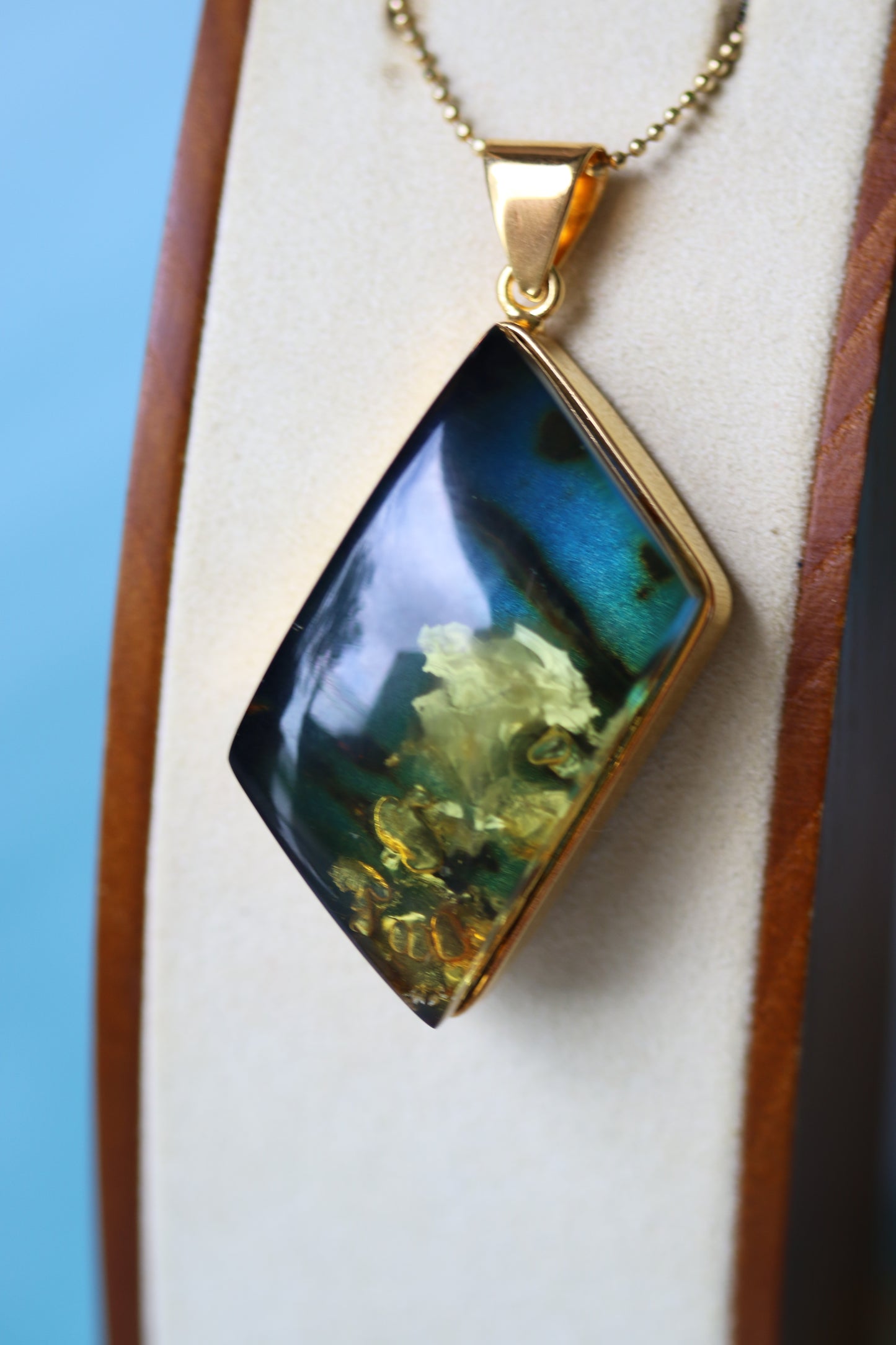 Unique Rhombus Shaped Blue Amber Pendant with Natural Inclusions in Gold Plated Silver