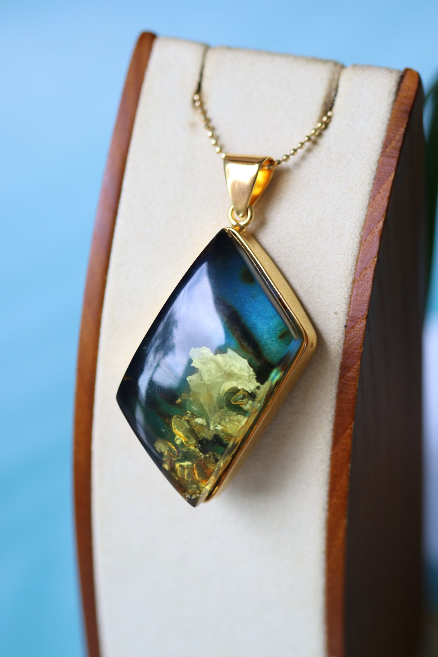 Unique Rhombus Shaped Blue Amber Pendant with Natural Inclusions in Gold Plated Silver