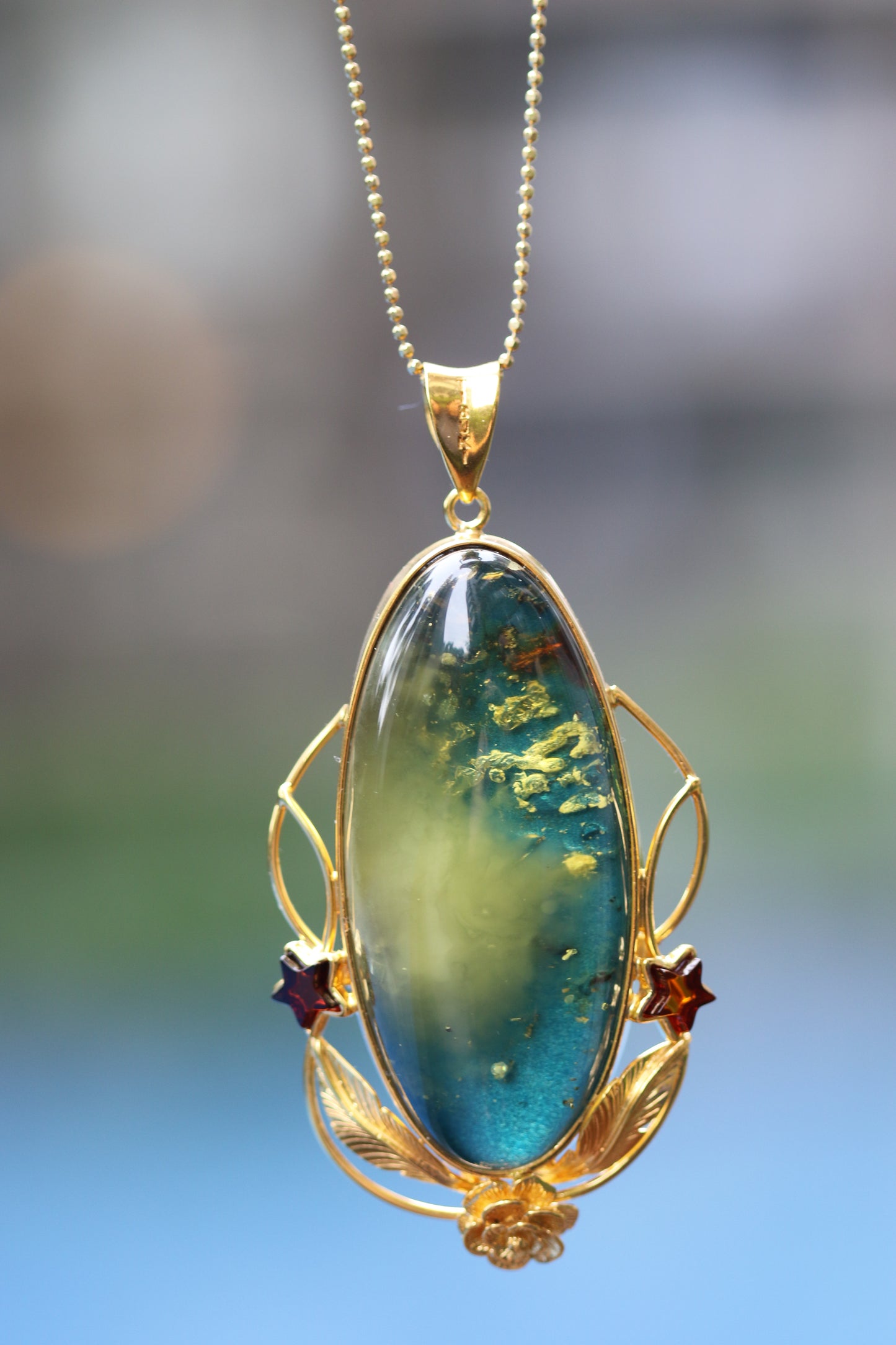 Large Unique Blue Amber Pendant with Milk Cloudy Inclusion and Cognac Stars in Gold Plated Silver