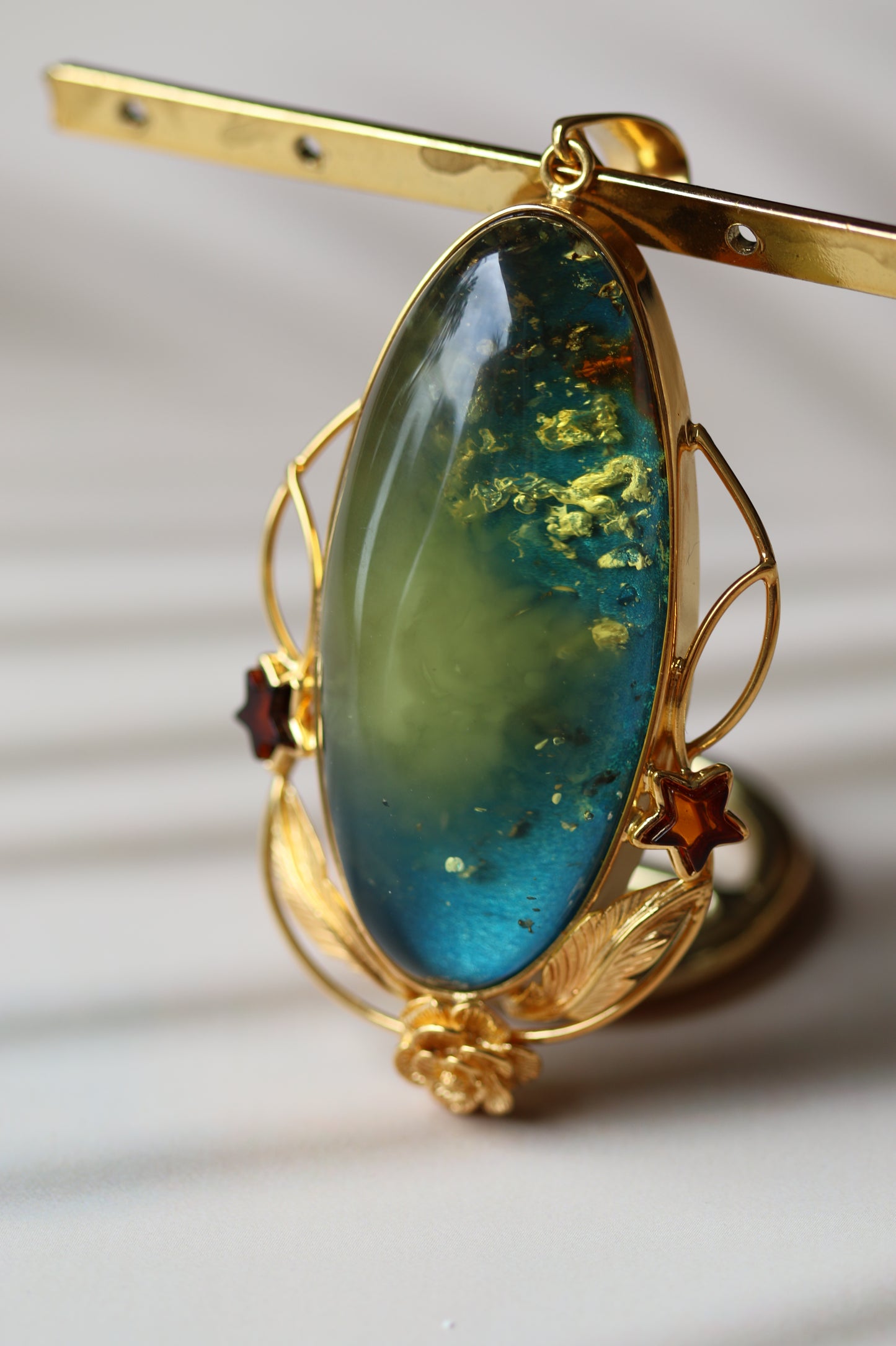 Large Unique Blue Amber Pendant with Milk Cloudy Inclusion and Cognac Stars in Gold Plated Silver