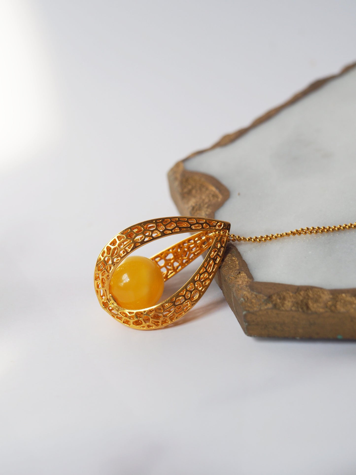 Chic Caged Triangle Pendant with a Butterscotch Amber Orb