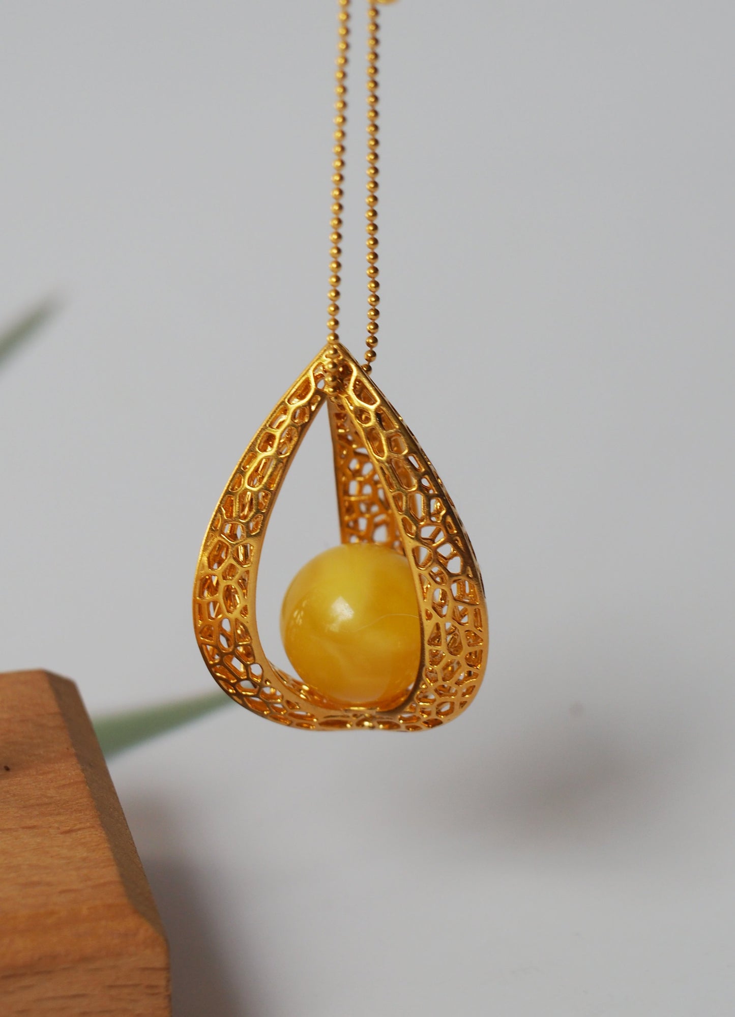 Chic Caged Triangle Pendant with a Butterscotch Amber Orb