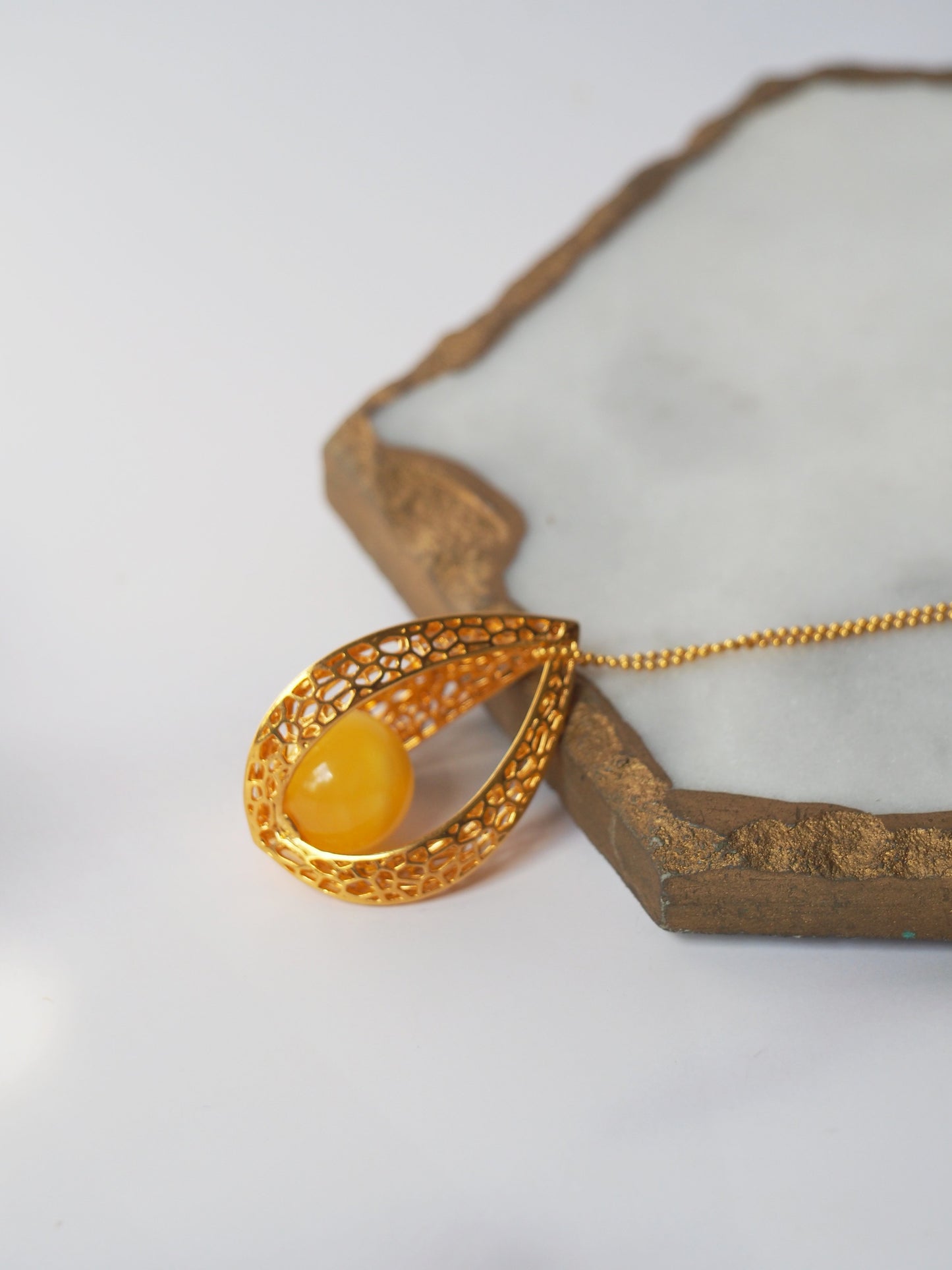 Chic Caged Triangle Pendant with a Butterscotch Amber Orb