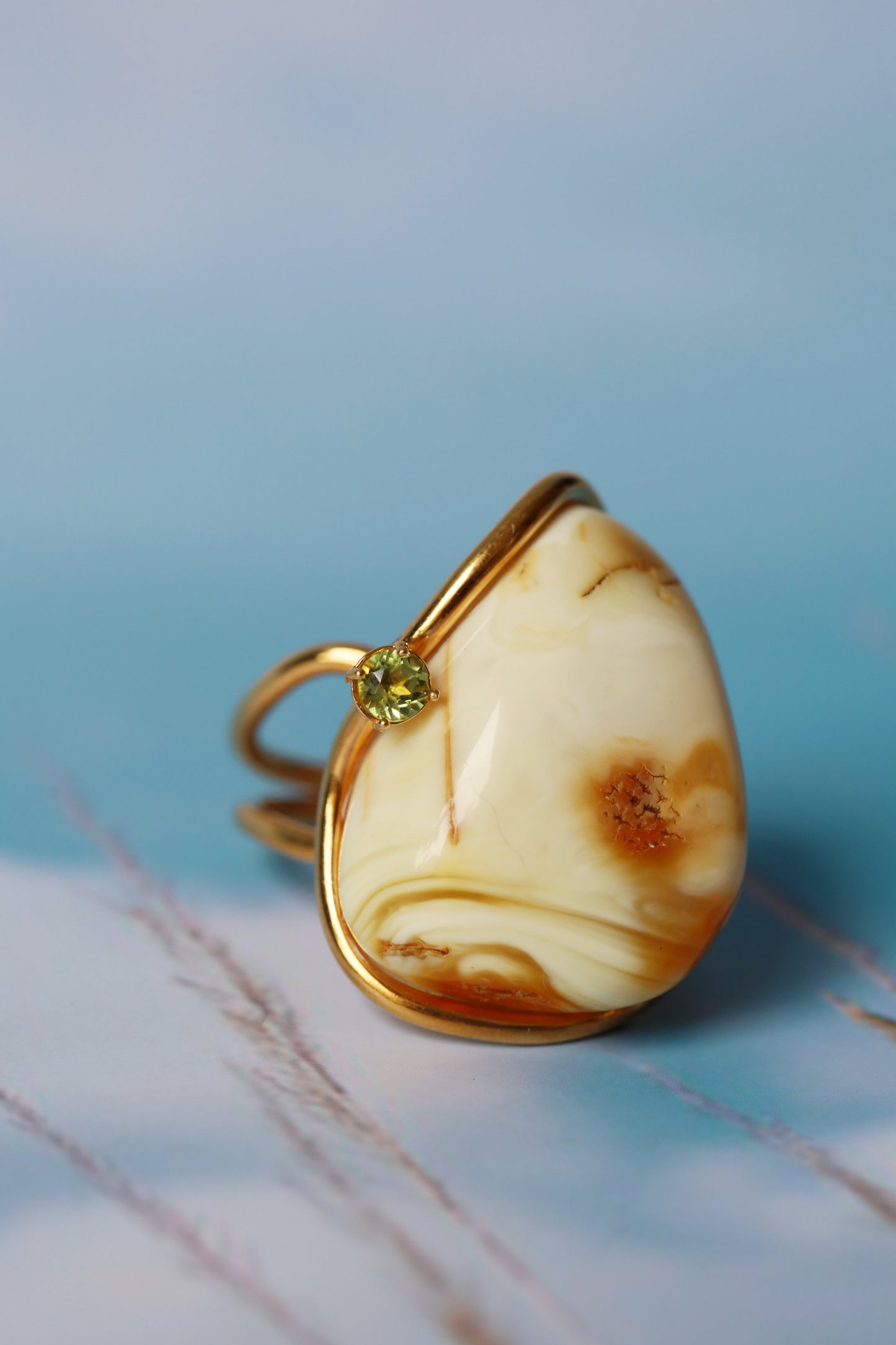 Irregular Royal White Amber Ring With Gold Plated Frame And Green Peridot