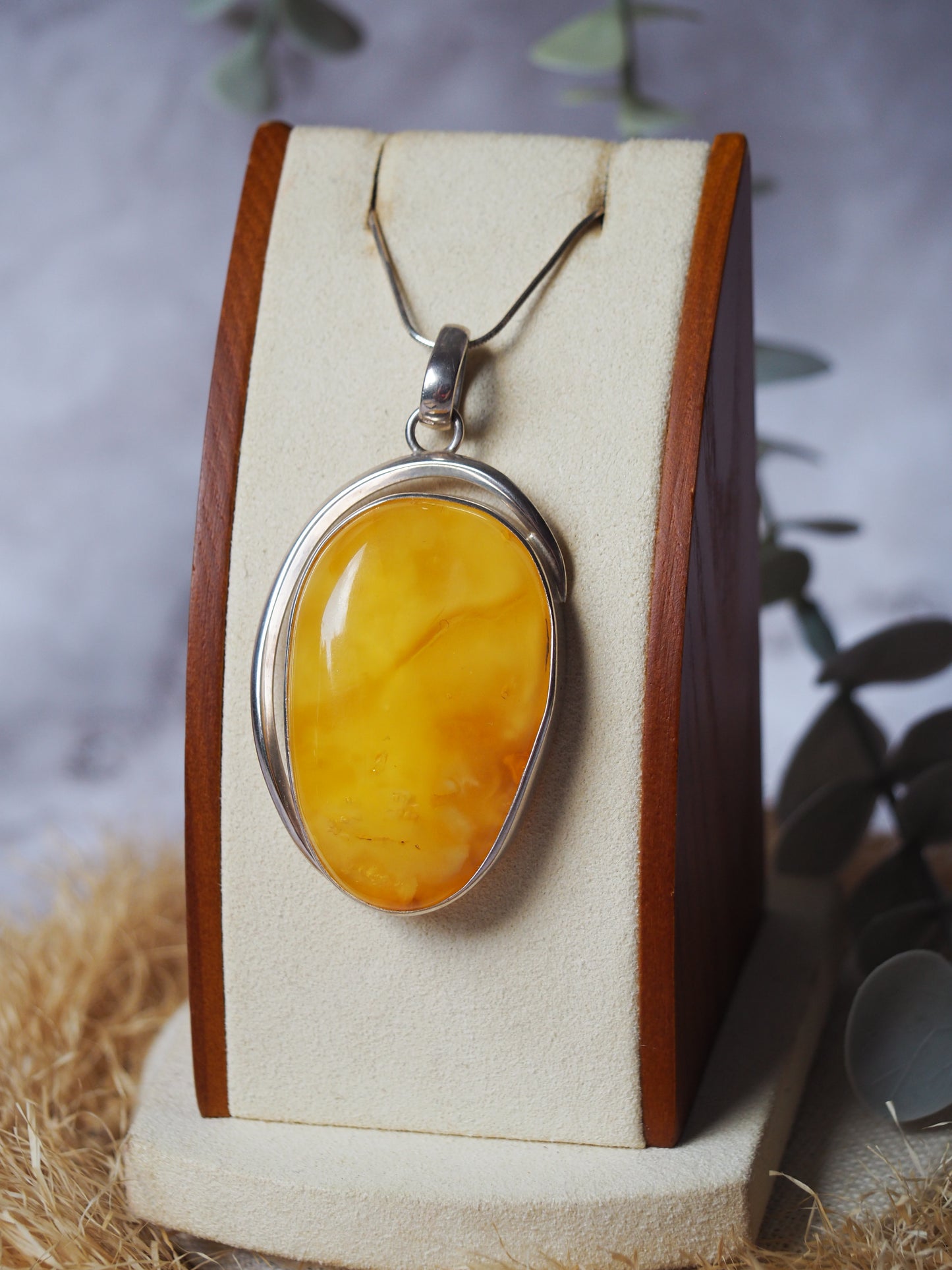 Natural butterscotch Amber Pendant with Raw Back in Silver Frame