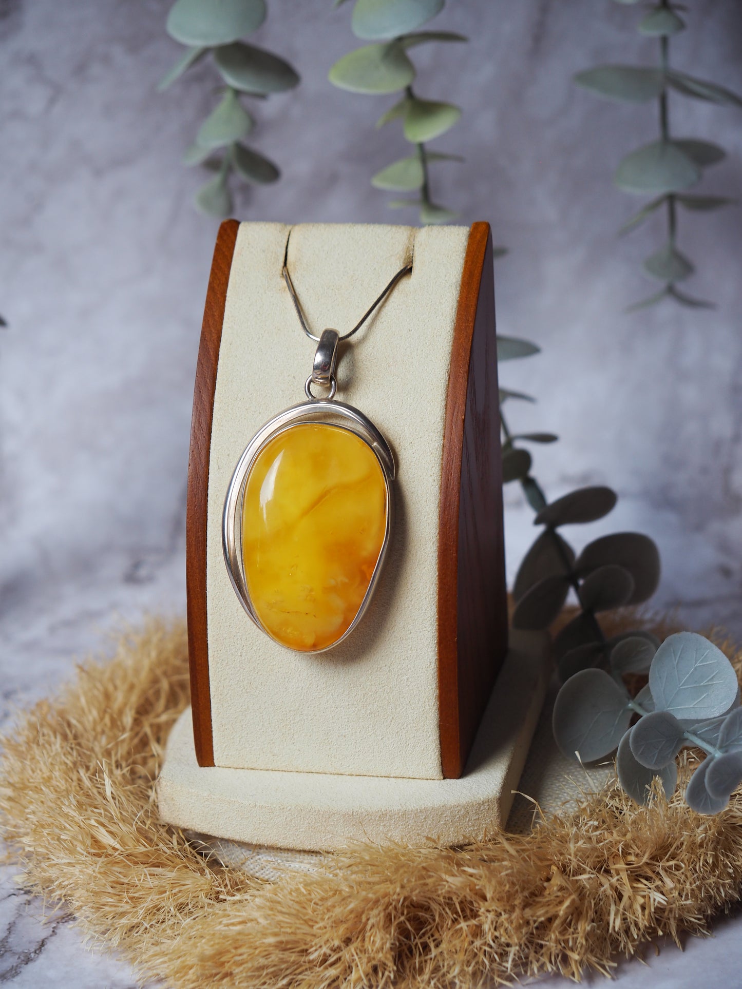 Natural butterscotch Amber Pendant with Raw Back in Silver Frame
