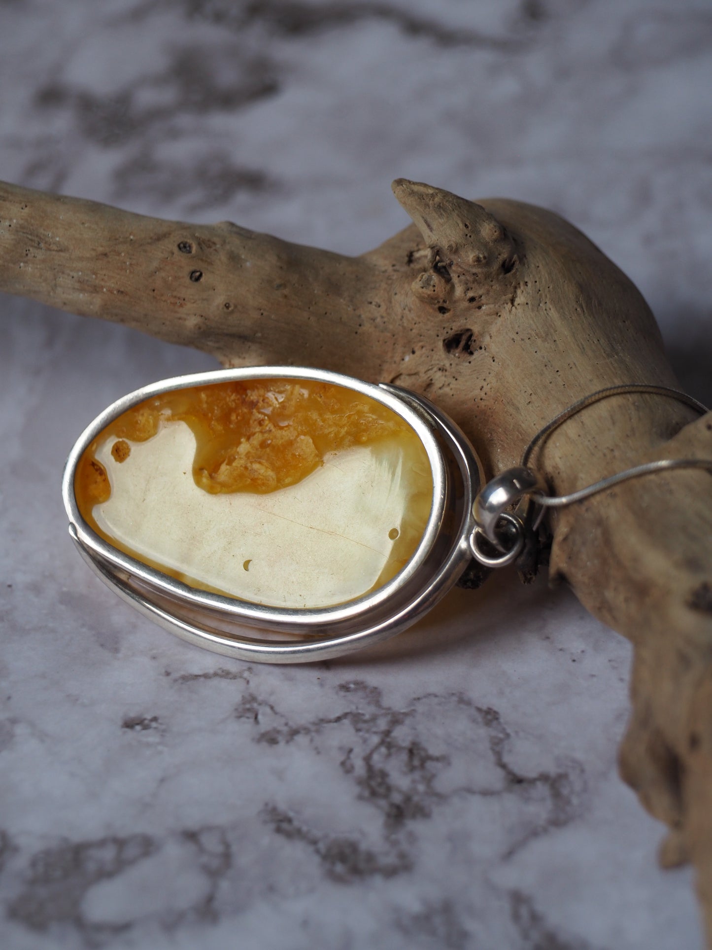 Natural butterscotch Amber Pendant with Raw Back in Silver Frame