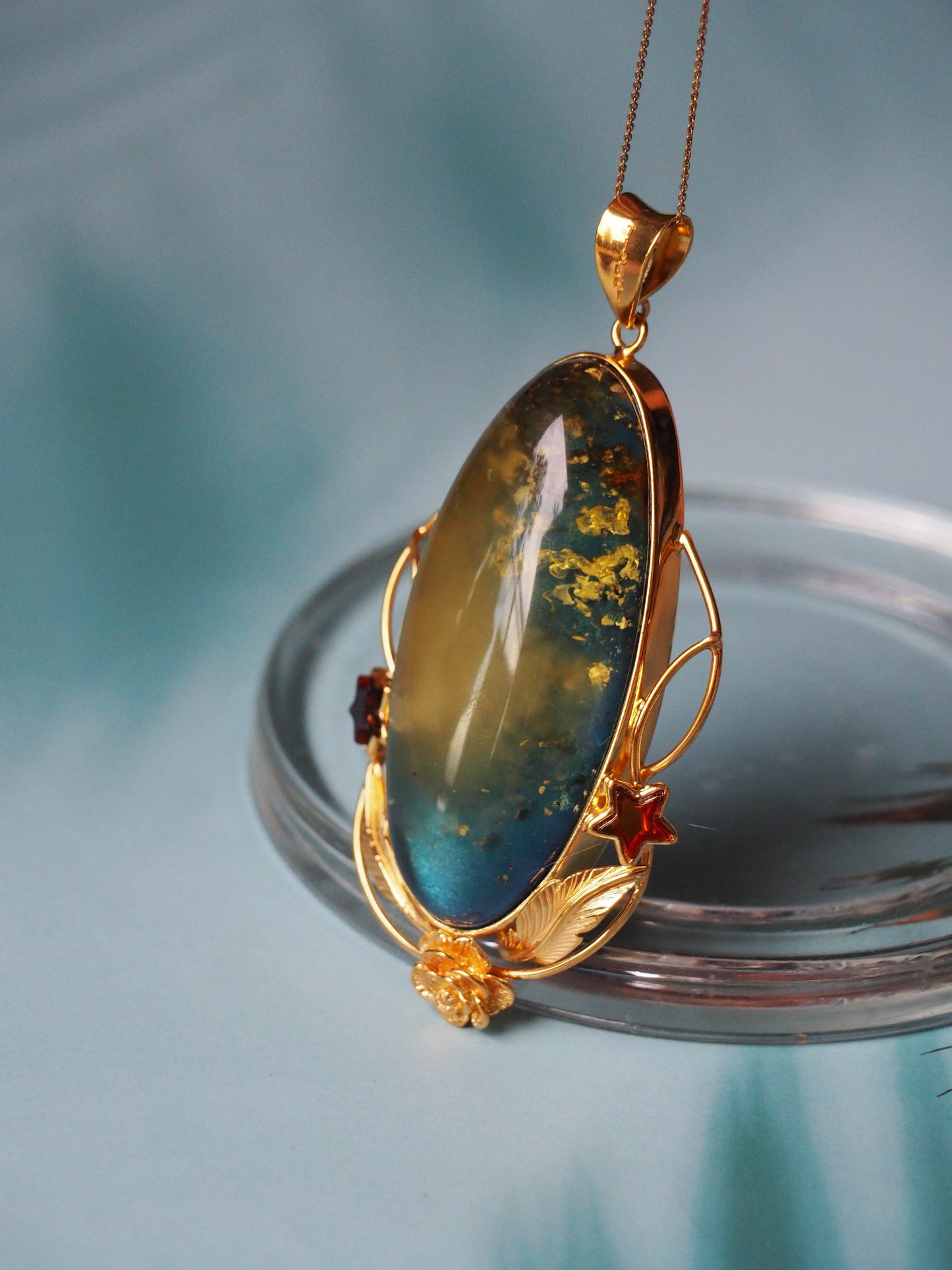 Large Unique Blue Amber Pendant with Milk Cloudy Inclusion and Cognac Stars in Gold Plated Silver