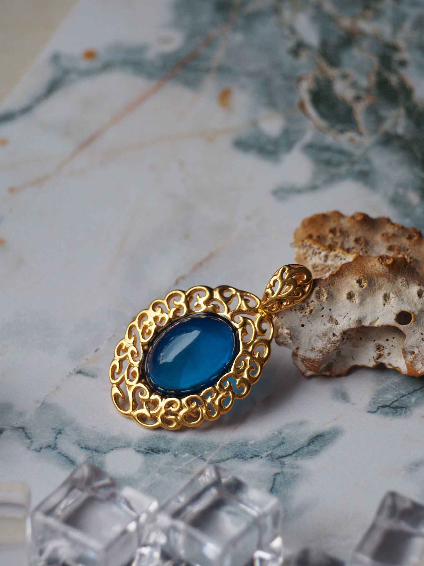 Elegant Blue Amber Oval Pendant in Golden Embroidery