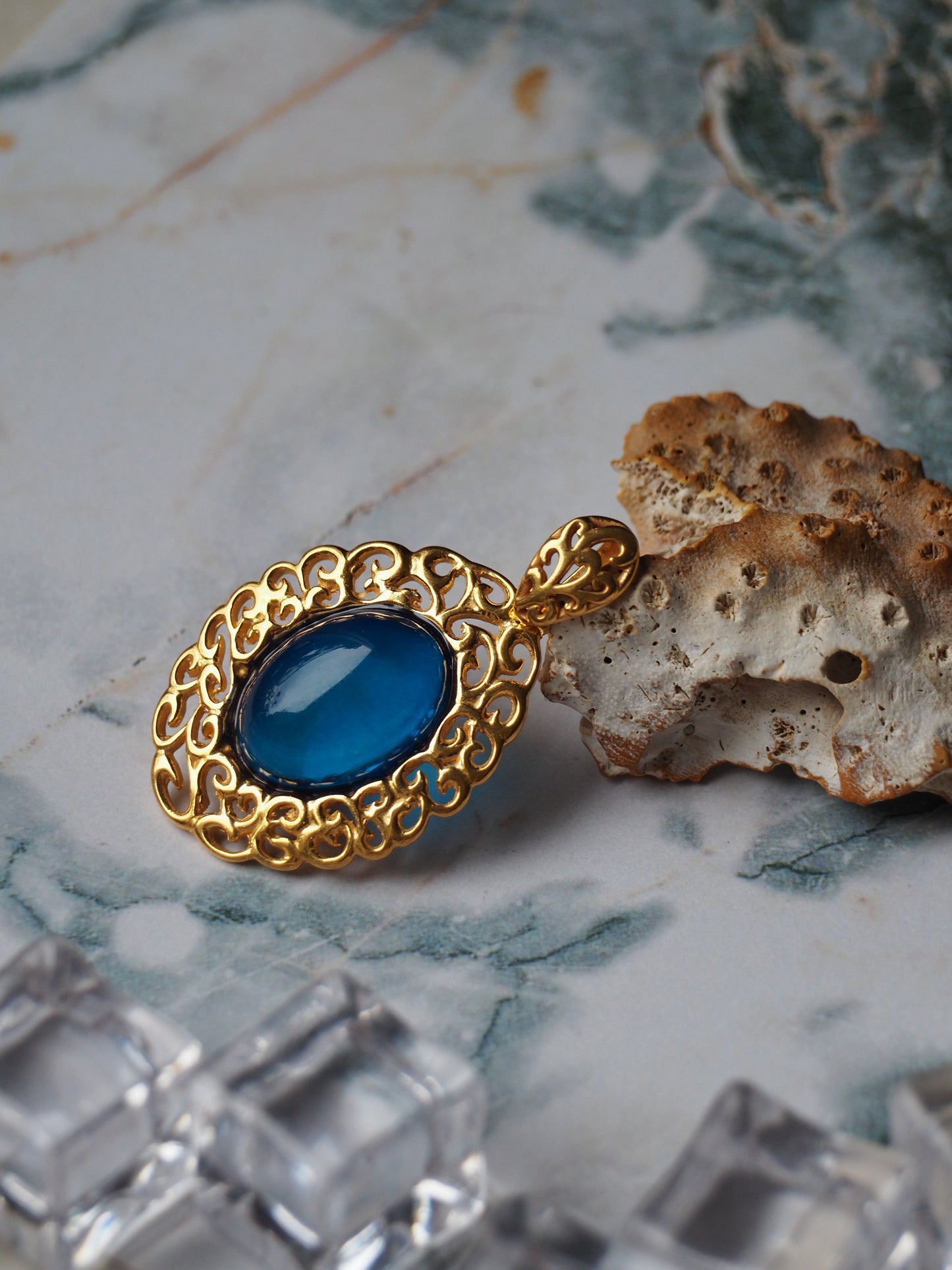 Elegant Blue Amber Oval Pendant in Golden Embroidery