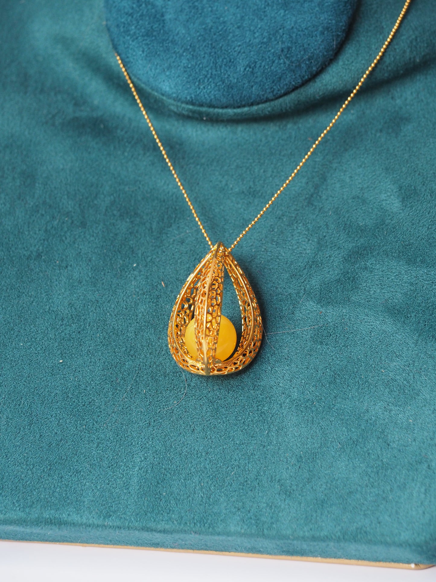 Chic Caged Triangle Pendant with a Butterscotch Amber Orb