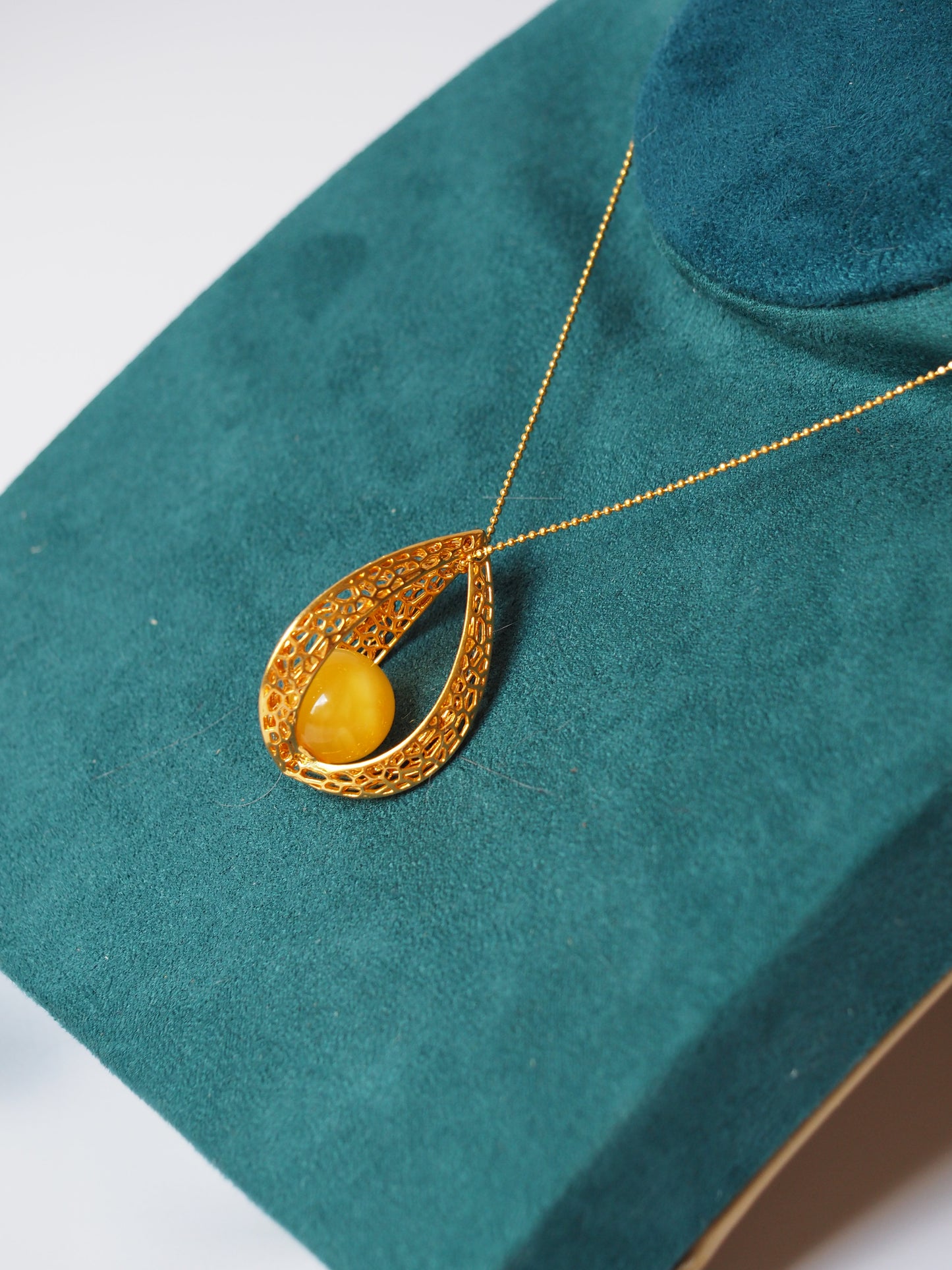 Chic Caged Triangle Pendant with a Butterscotch Amber Orb