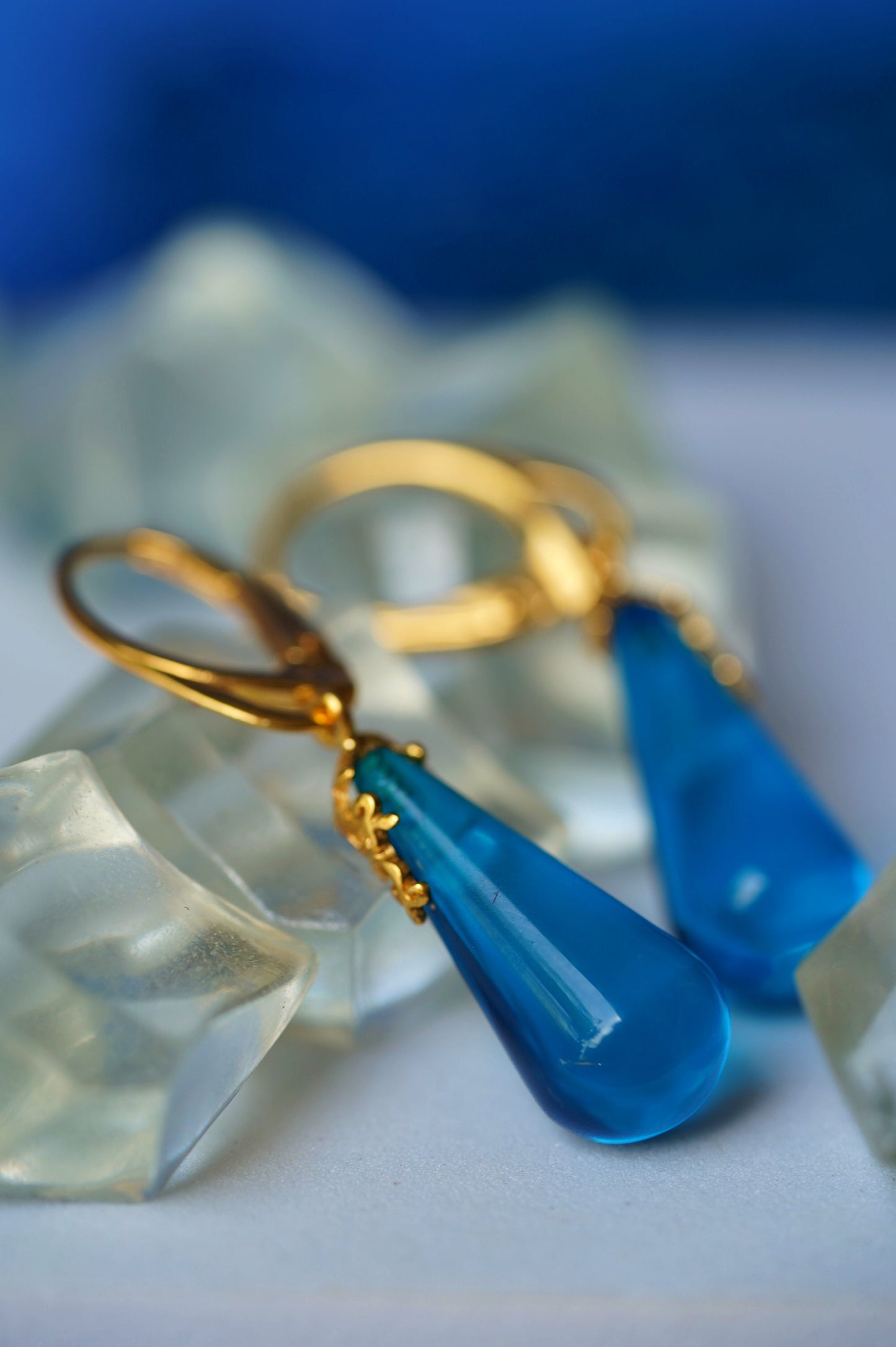 Blue Tear Shaped Amber Earrings in Gold Pleated Silver