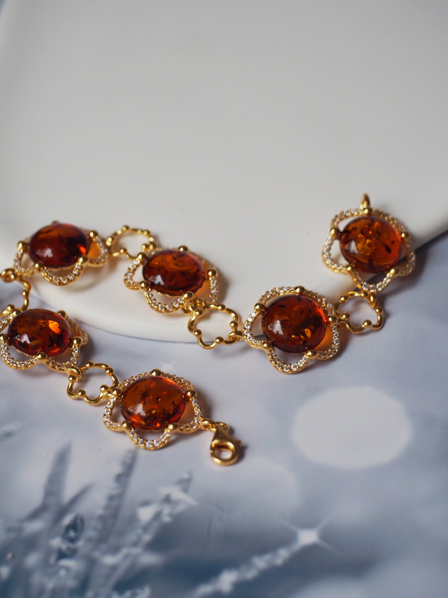 Delicate Flower Shaped Cognac Amber Bracelet with Cubic Zirconia in Gold Plated Silver