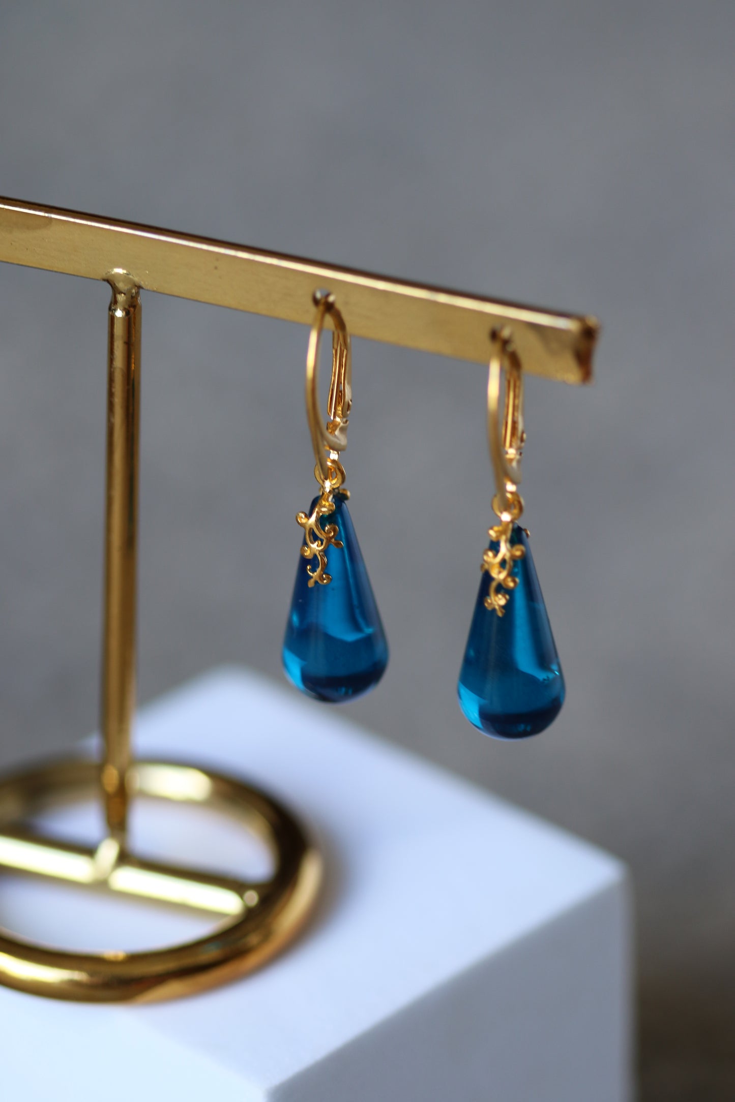 Blue Tear Shaped Amber Earrings in Gold Pleated Silver