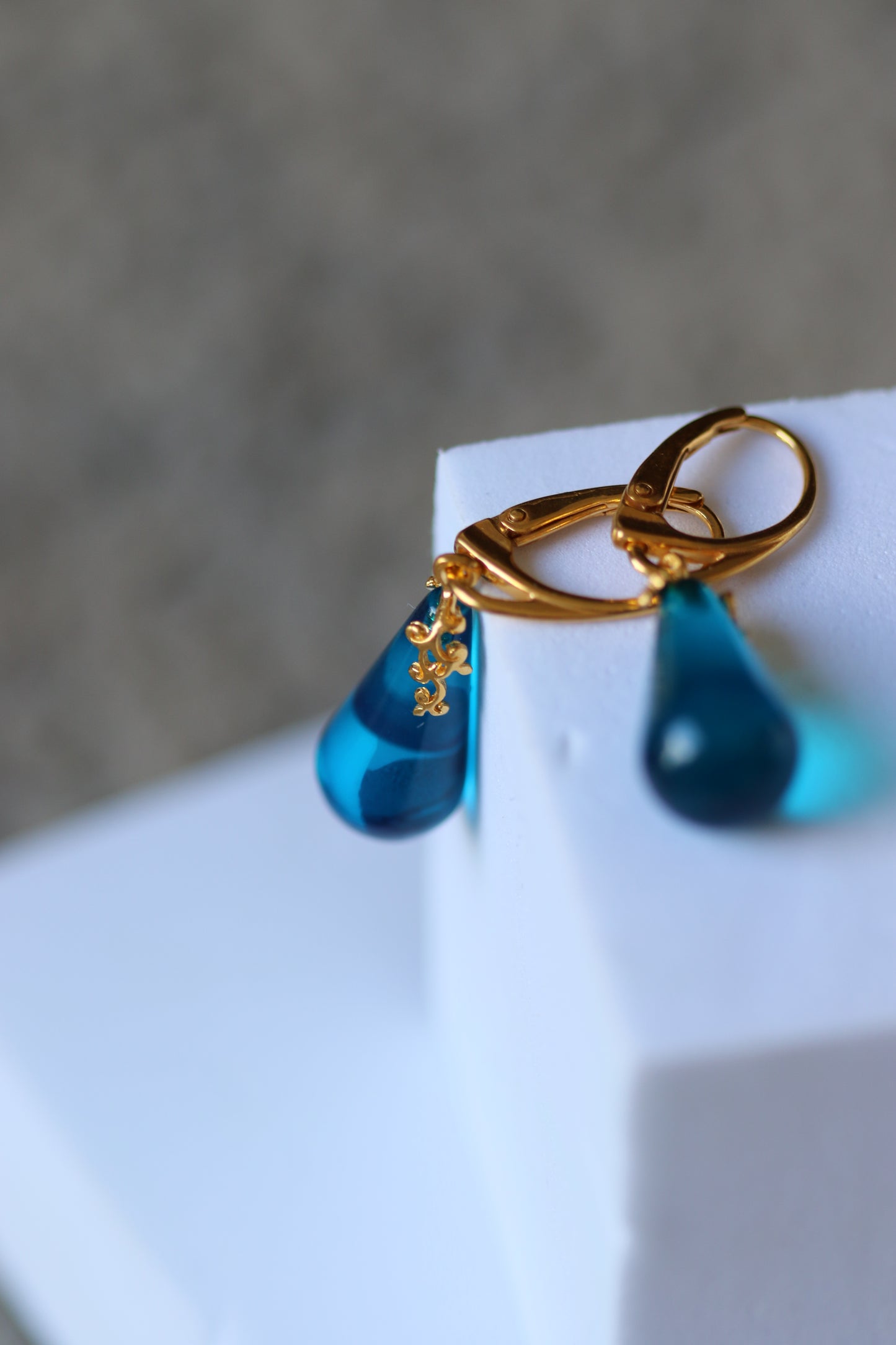 Blue Tear Shaped Amber Earrings in Gold Pleated Silver