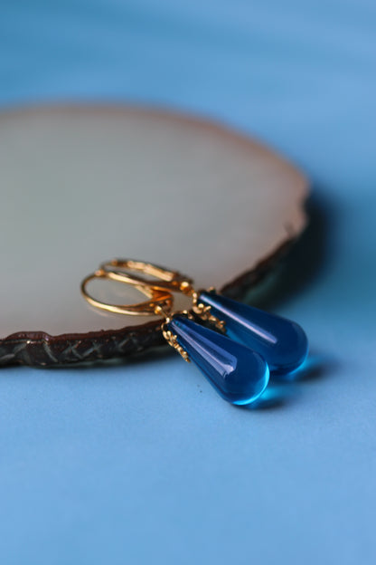 Blue Tear Shaped Amber Earrings in Gold Pleated Silver