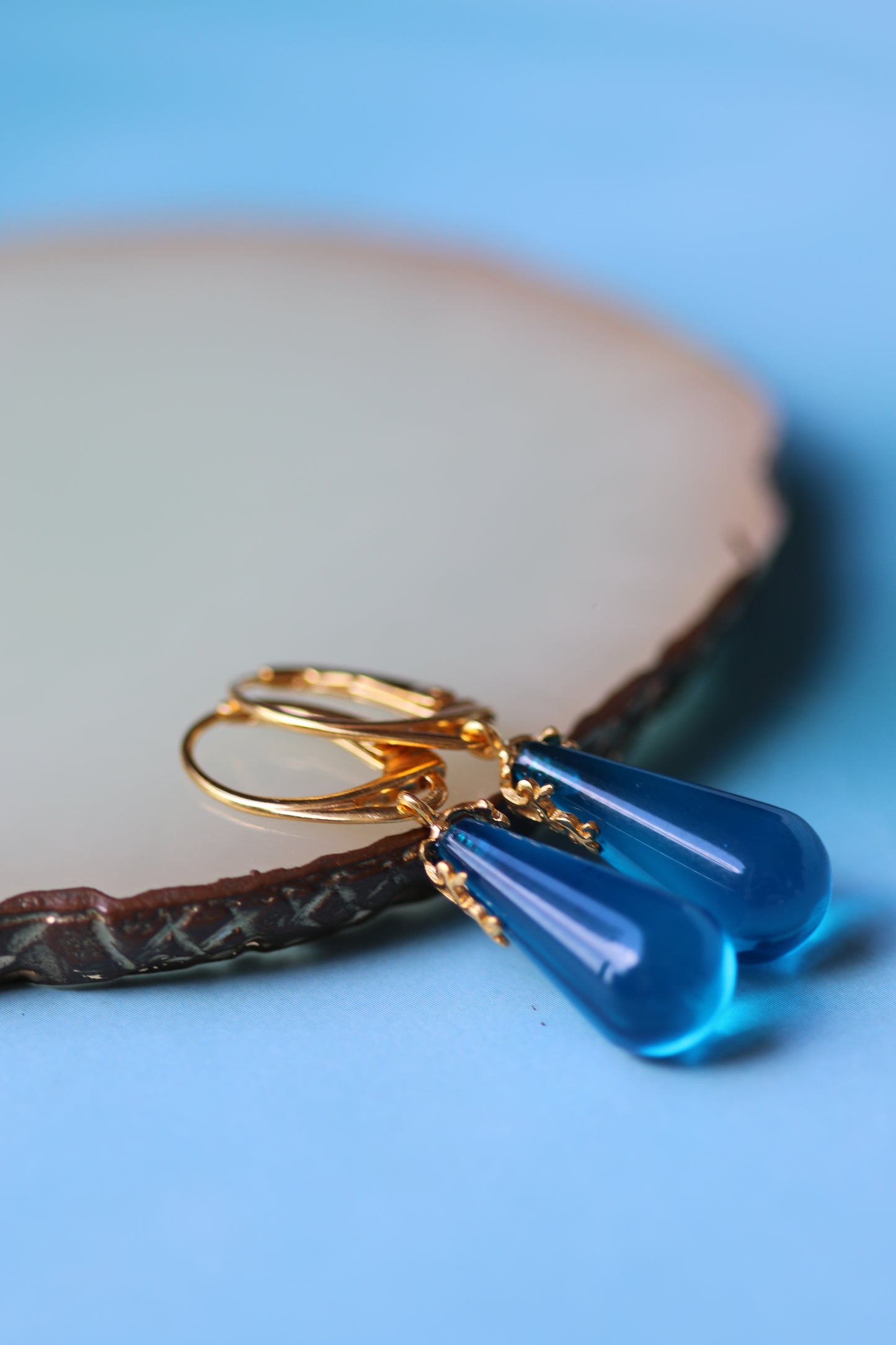 Blue Tear Shaped Amber Earrings in Gold Pleated Silver