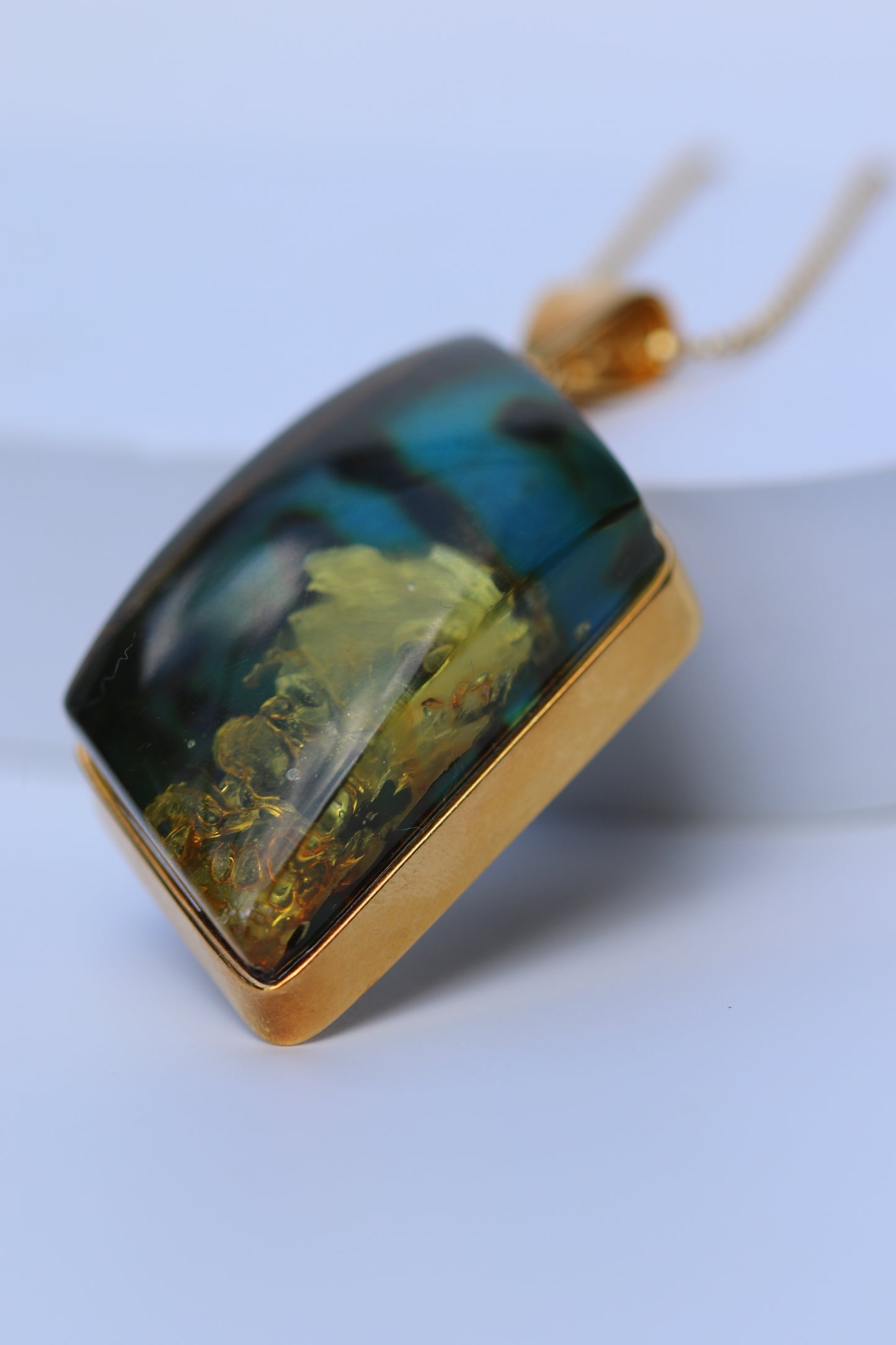 Unique Rhombus Shaped Blue Amber Pendant with Natural Inclusions in Gold Plated Silver
