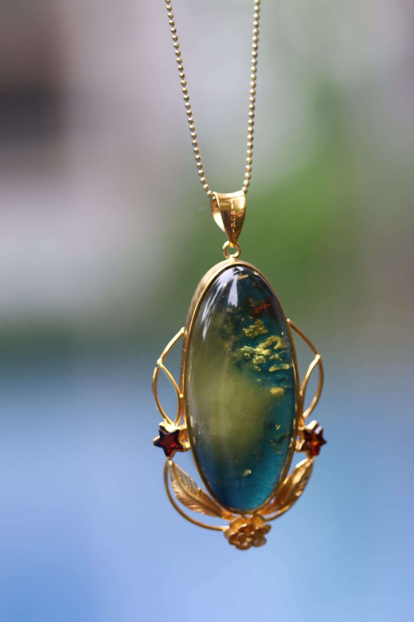 Large Unique Blue Amber Pendant with Milk Cloudy Inclusion and Cognac Stars in Gold Plated Silver