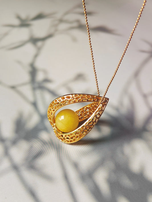 Chic Caged Triangle Pendant with a Butterscotch Amber Orb