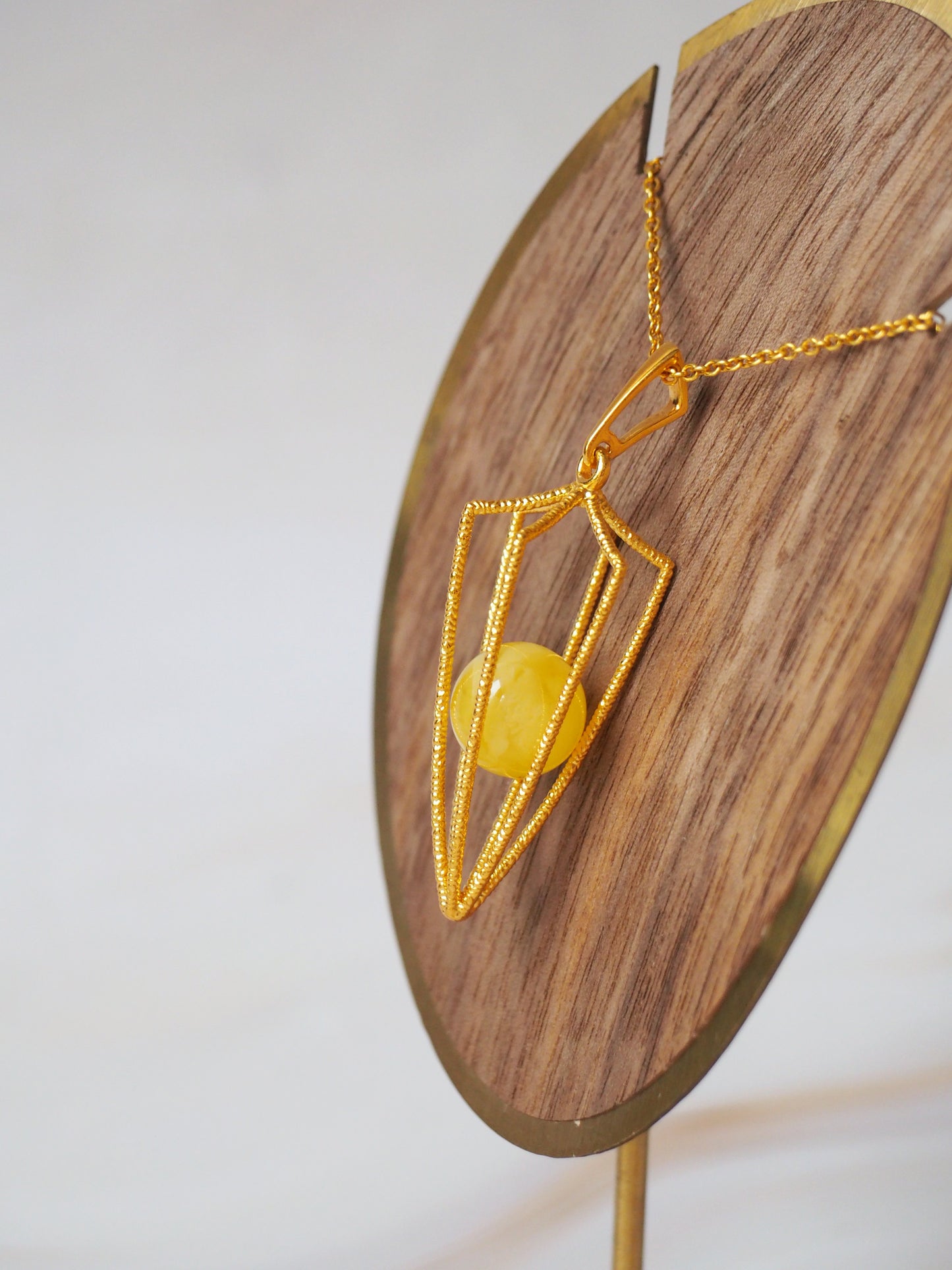 Geometric Cage Pendant With Butterscotch Amber And Gold Plated Silver