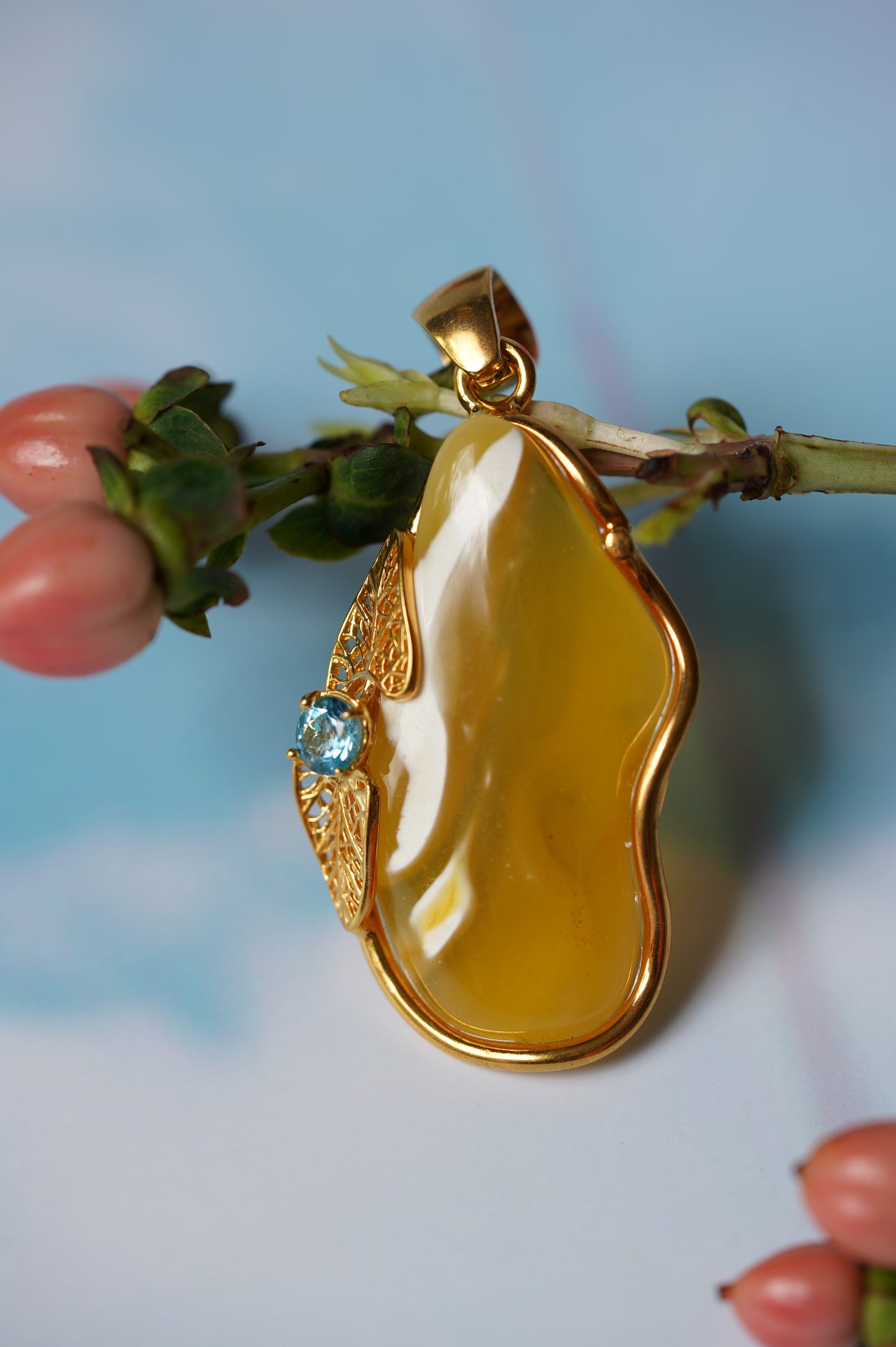 Natural Irregular Honey / Royal White Amber Pendant in Gold Plated Silver Frame with Blue Topaz