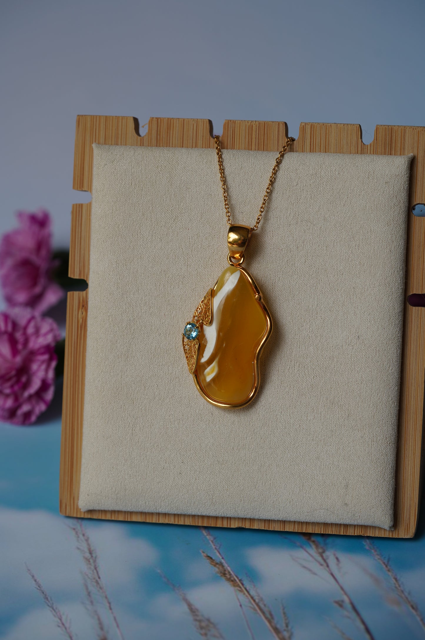 Natural Irregular Honey / Royal White Amber Pendant in Gold Plated Silver Frame with Blue Topaz