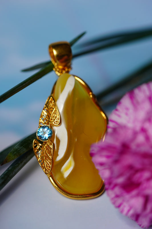 Natural Irregular Honey / Royal White Amber Pendant in Gold Plated Silver Frame with Blue Topaz
