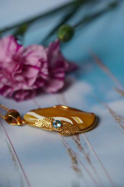 Natural Irregular Honey / Royal White Amber Pendant in Gold Plated Silver Frame with Blue Topaz