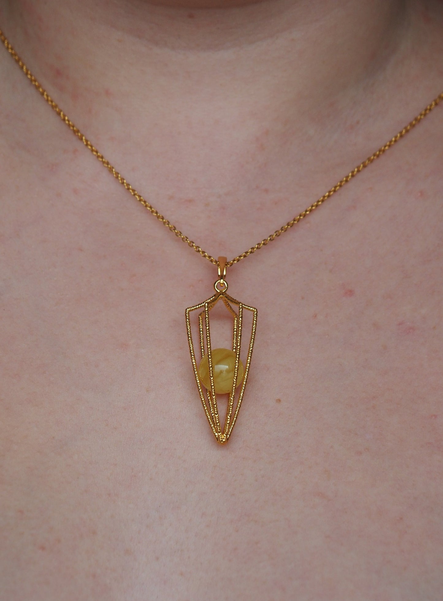 Geometric Cage Pendant With Butterscotch Amber And Gold Plated Silver