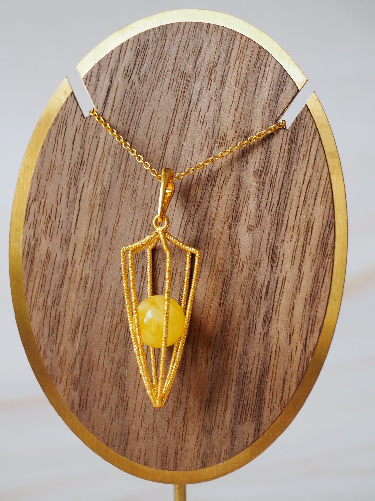 Geometric Cage Pendant With Butterscotch Amber And Gold Plated Silver