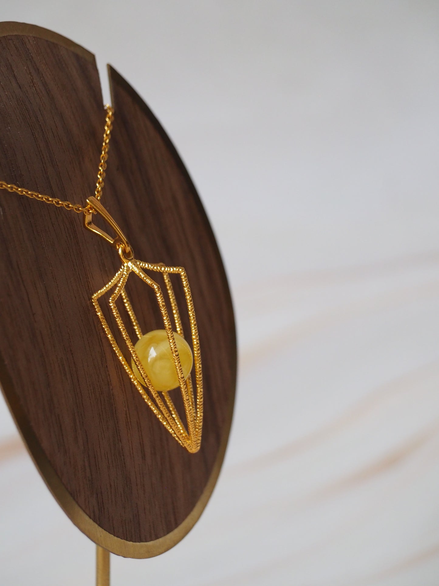 Geometric Cage Pendant With Butterscotch Amber And Gold Plated Silver