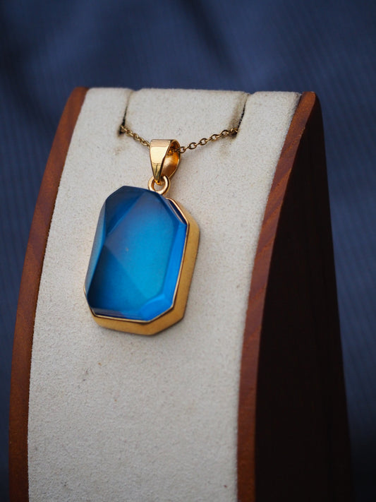 Irregular Polished Blue Amber Pendant in Gold Pleated Silver